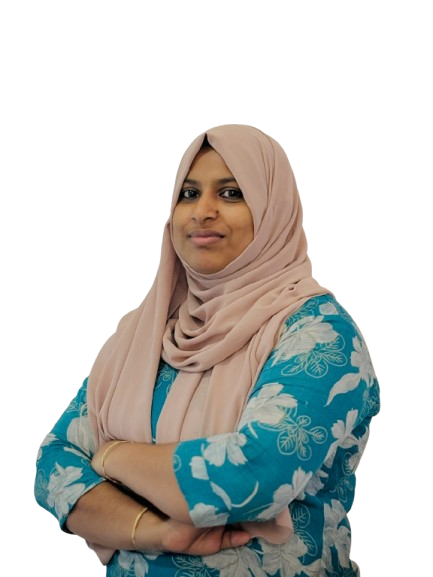 Performance marketing freelancer in Ernakulam standing confidently with arms crossed, wearing a beige hijab and blue floral outfit.