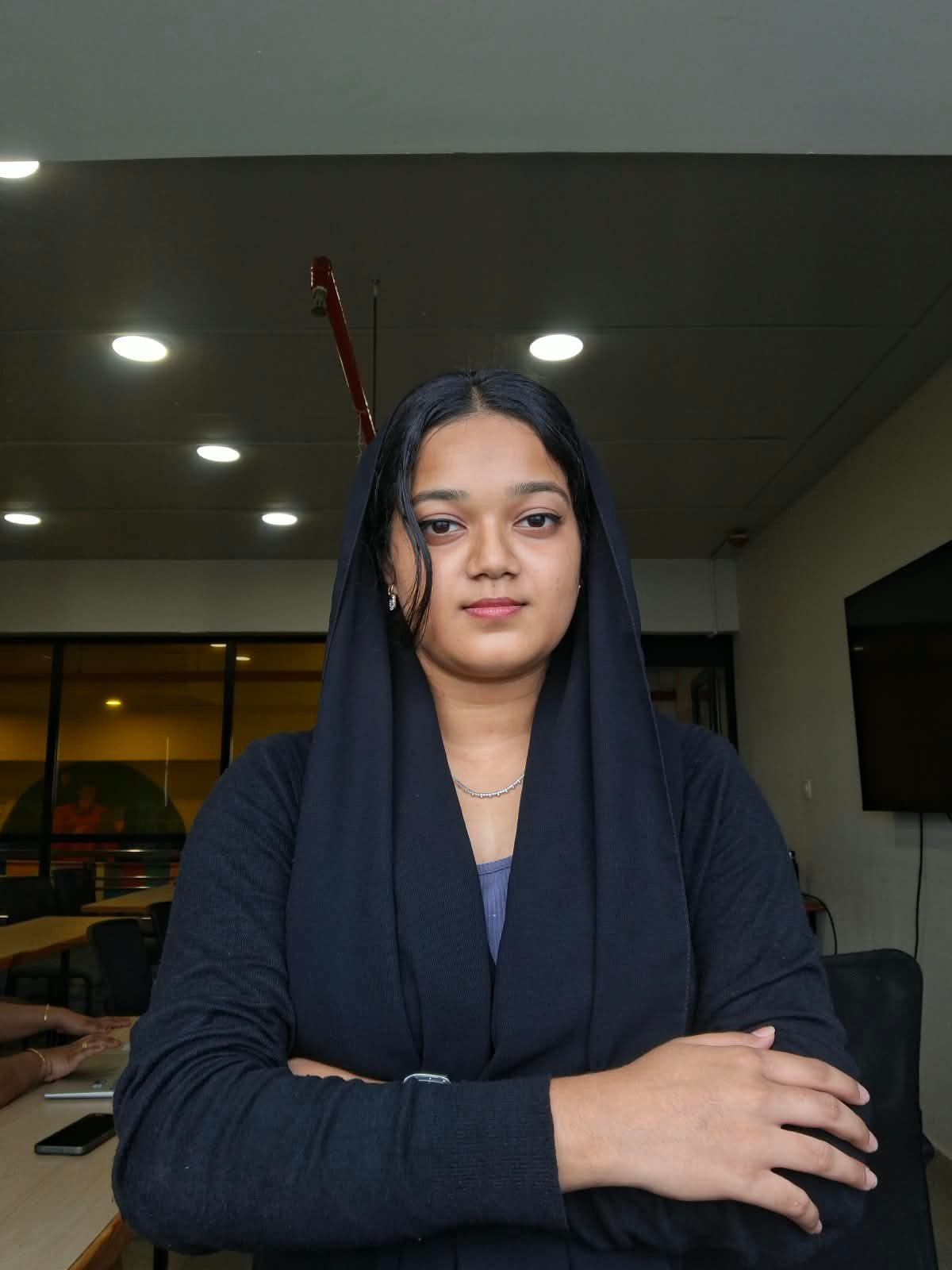 Performance marketing freelancer in Ernakulam – client testimonial, young woman in office with arms crossed